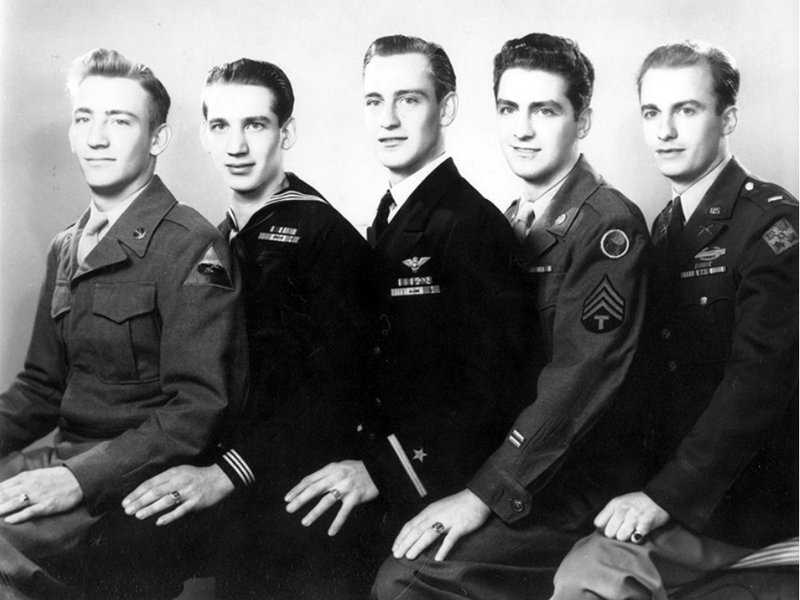 The five Giftos brothers seated together, four in uniform