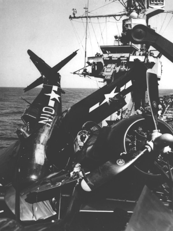 FM-2 Wildcat N10 tipped onto its nose against the island of the carrier