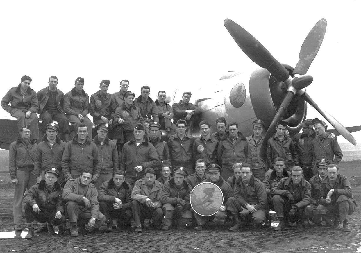 Group photograph of squadron personnel in front of a P-47 Thunderbolt