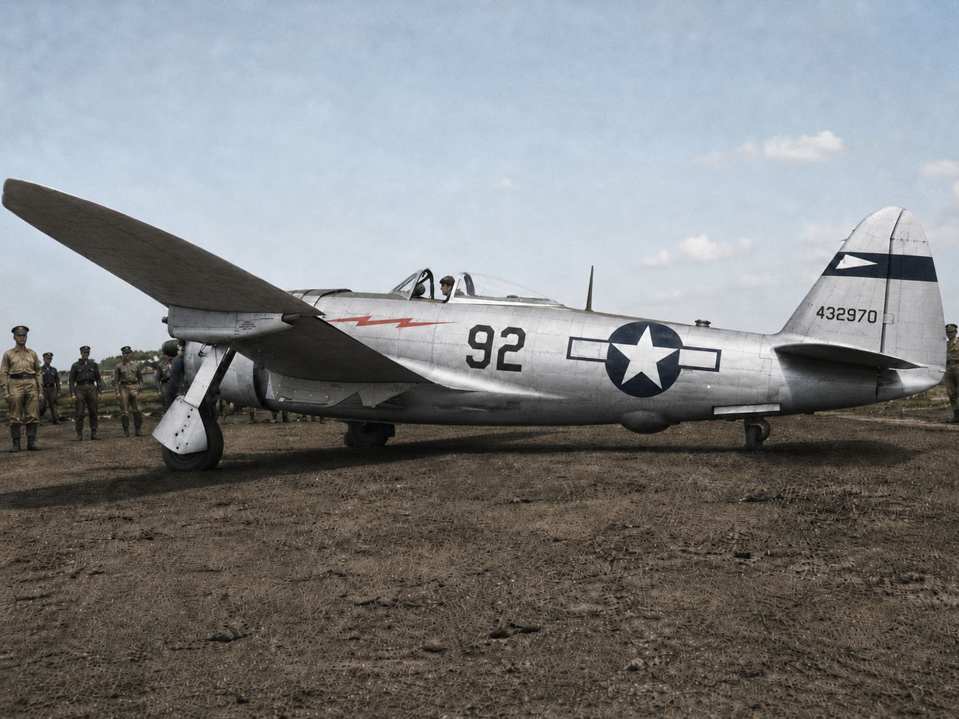 P-47 Thunderbolt 92 in natural metal on a muddy airfield
