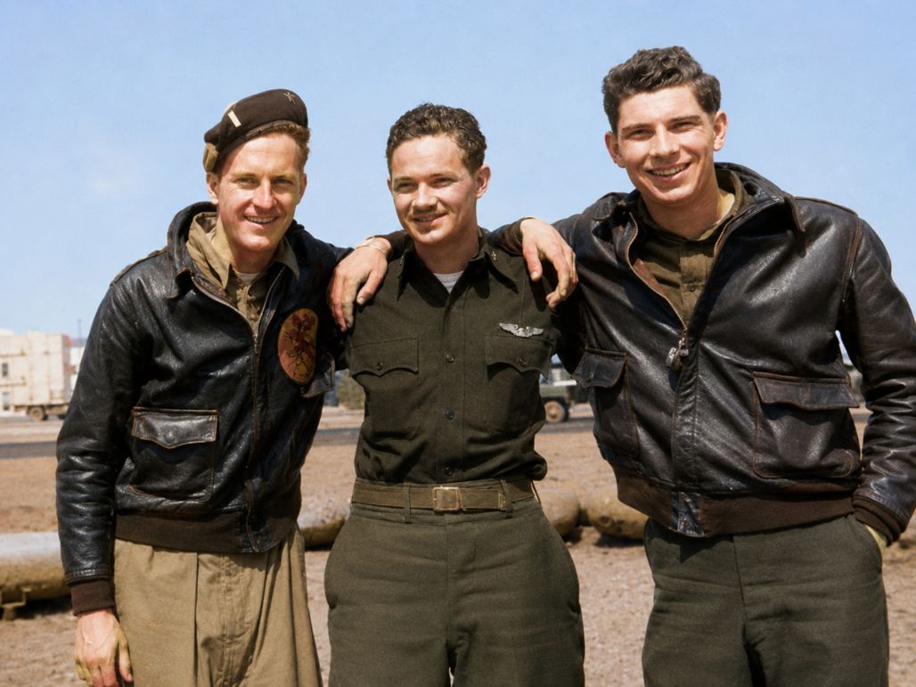 Kandis between two fellow airmen in leather flying jackets